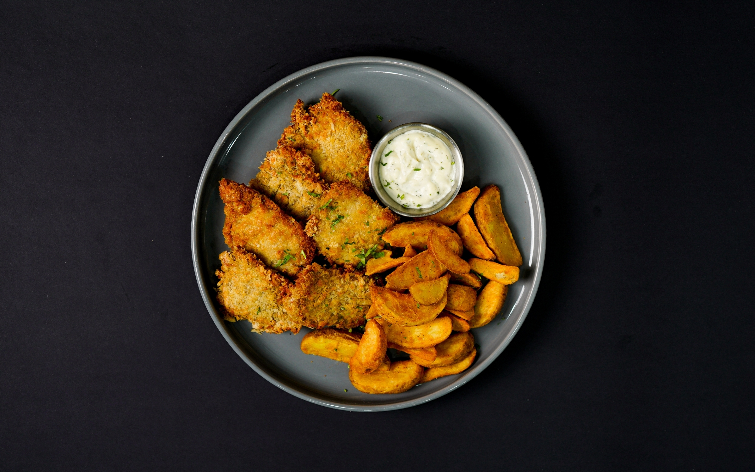 Breaded fish with potato wedges